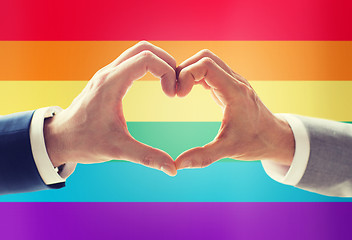 Image showing close up of male gay couple hands showing heart