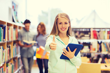 Image showing happy student girl with tablet pc in library