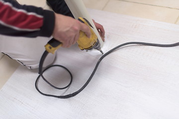 Image showing repairman working with drilling machine