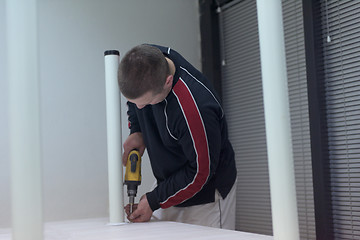 Image showing repairman working with drilling machine