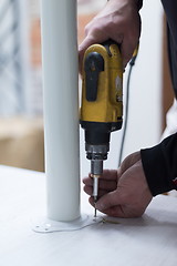 Image showing repairman working with drilling machine