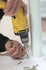 Image showing repairman working with drilling machine