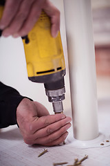 Image showing repairman working with drilling machine