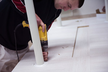 Image showing repairman working with drilling machine