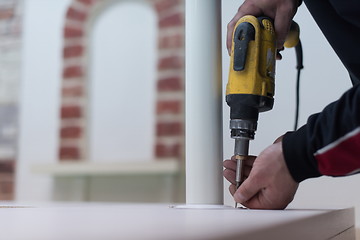 Image showing repairman working with drilling machine