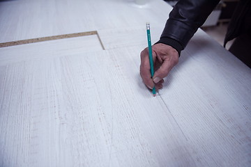 Image showing carpenter worker measuring