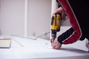 Image showing repairman working with drilling machine