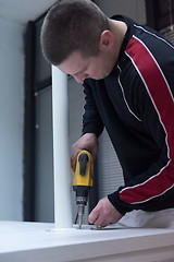 Image showing repairman working with drilling machine