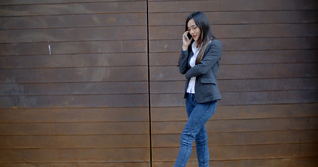 Image showing Stylish trendy woman chatting on a mobile