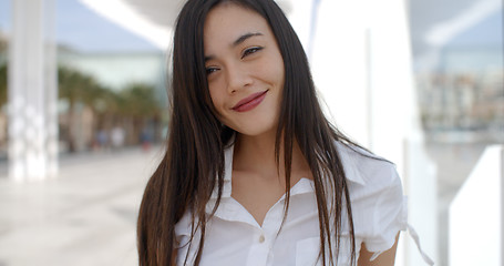 Image showing Pretty young woman in a white summer top