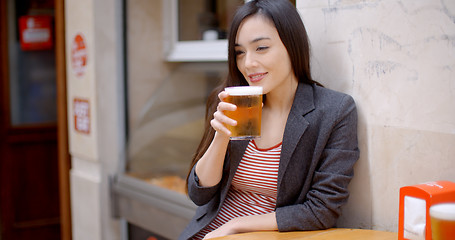 Image showing Young woman relaxing enjoying a beer