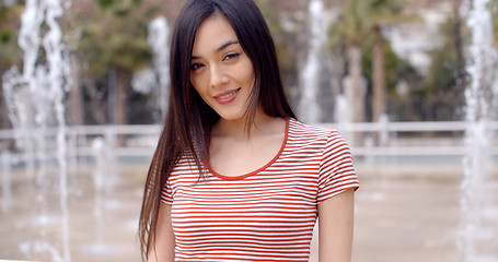 Image showing Beautiful young woman in front of fountains