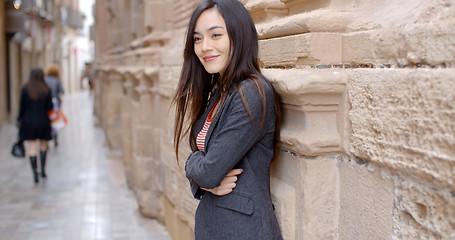 Image showing Stylish woman standing waiting in an urban alley