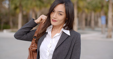 Image showing Gorgeous young woman putting purse over shoulder