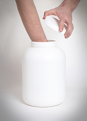 Image showing Bodybuilding and Sports themehands holding a plastic jar with a 