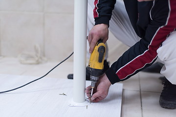 Image showing repairman working with drilling machine