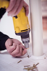 Image showing repairman working with drilling machine