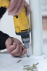 Image showing repairman working with drilling machine