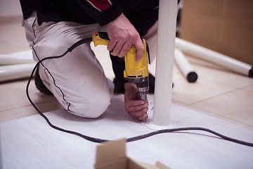 Image showing repairman working with drilling machine