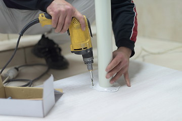 Image showing repairman working with drilling machine