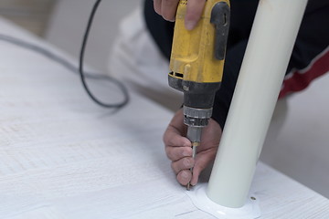 Image showing repairman working with drilling machine