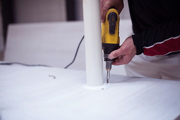 Image showing repairman working with drilling machine