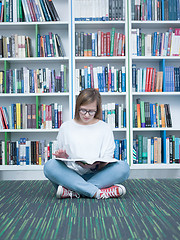 Image showing student girl reading book in library