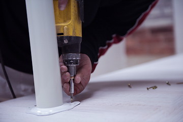 Image showing repairman working with drilling machine