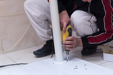 Image showing repairman working with drilling machine