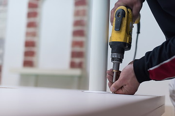 Image showing repairman working with drilling machine