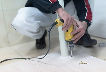 Image showing repairman working with drilling machine