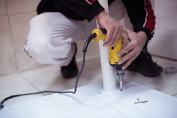 Image showing repairman working with drilling machine