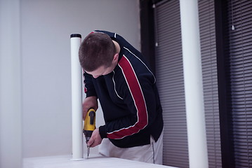 Image showing repairman working with drilling machine