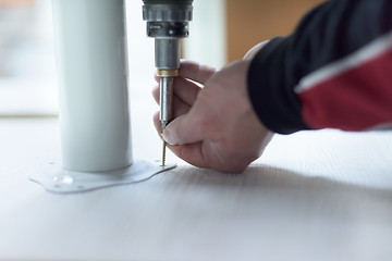 Image showing repairman working with drilling machine