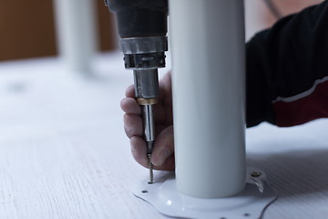 Image showing repairman working with drilling machine