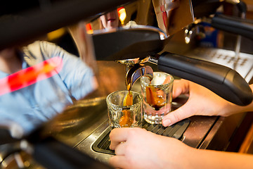 Image showing close up of woman doing espresso by coffee machine