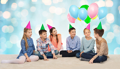 Image showing happy smiling children in party hats on birthday