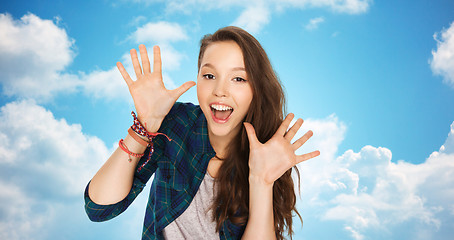 Image showing happy laughing pretty teenage girl showing hands