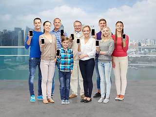 Image showing group of smiling people with smartphones