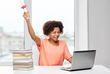 Image showing happy african woman with laptop, books and diploma