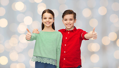 Image showing happy boy and girl showing thumbs up