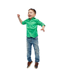 Image showing happy little boy jumping in air