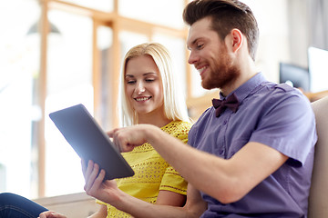 Image showing happy creative team with tablet pc in office