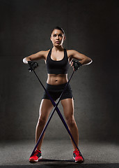 Image showing woman with expander exercising in gym