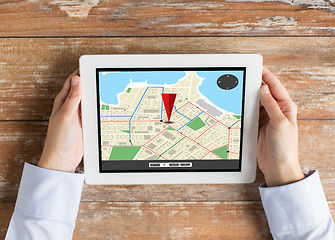 Image showing close up of hands with navigator map on tablet pc