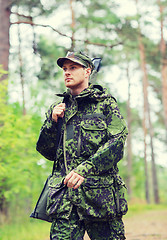 Image showing young soldier or hunter with gun in forest