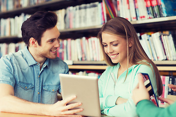 Image showing happy students with tablet pc in library