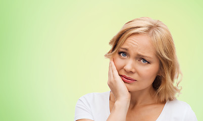 Image showing unhappy woman suffering toothache