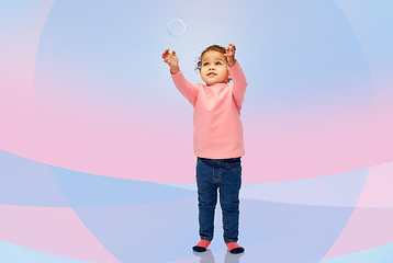 Image showing little baby girl playing with soap bubble