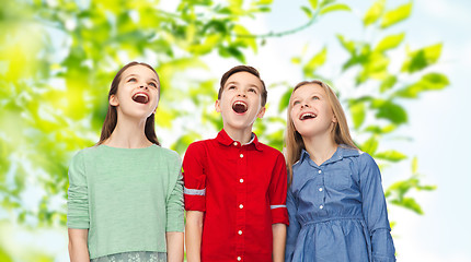 Image showing amazed boy and girls looking up